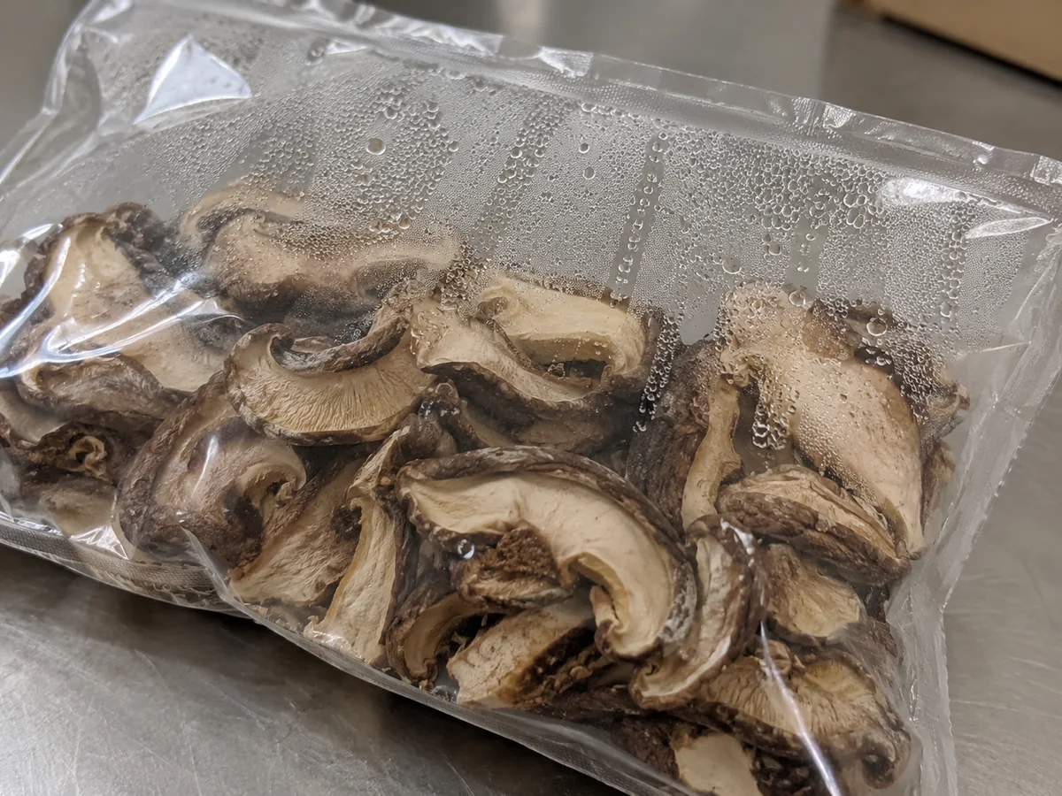 Condensation droplets inside a clear dried-mushroom bag with clumped slices