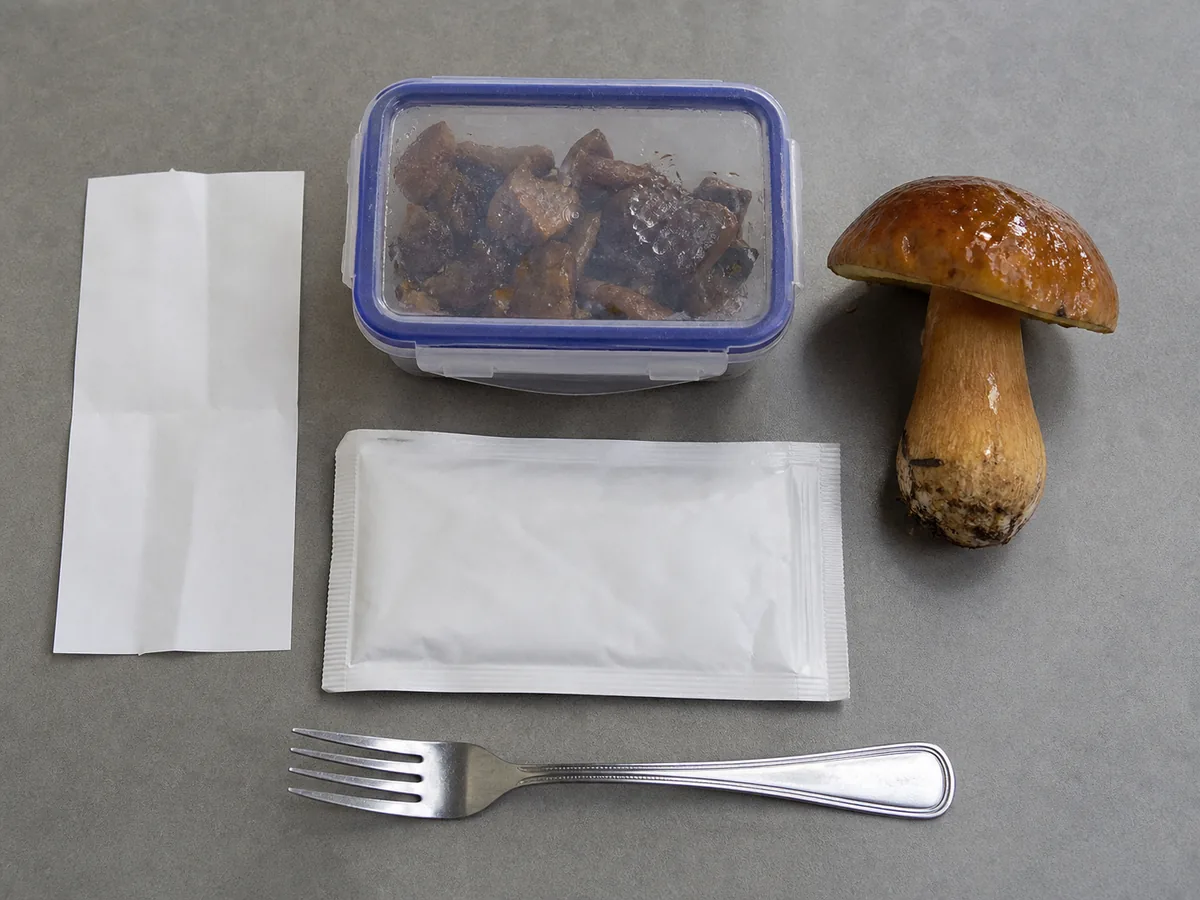 Sealed slippery jack leftovers beside an intact specimen, blank receipt, and dinner fork - evidence after a slippery jack meal